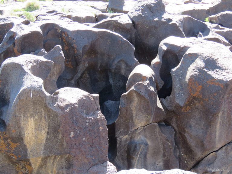 The smooth, rounded shapes of volcanic rock shaped by eons of running water.