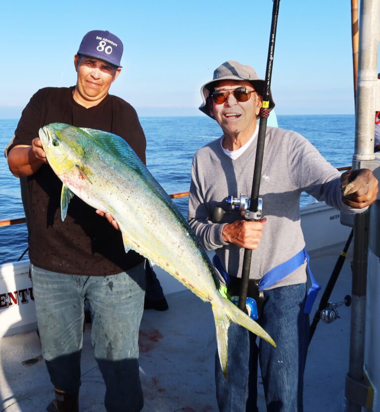 ASPEN ANGLER BILL FONTANA, right, with his first-ever dorado gaffed by Captain Ricky Perez, left, aboard the Sea Adventure 80.