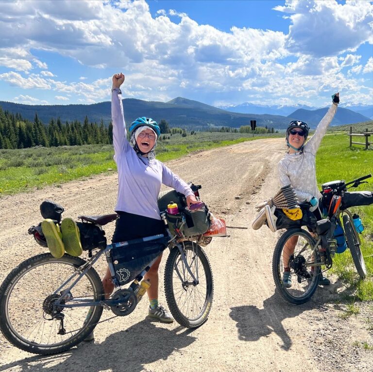 Dasha Yurkevich and Zora Kramer celebrate their ride along the Continental Divide.
