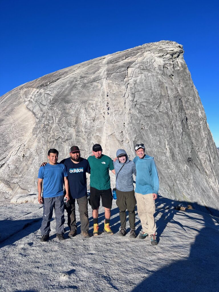 Climbers ascend the cables up the steep slope of Half Dome.