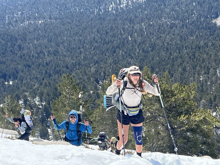 Pacific Crest Trail hikers power their way up a snowy mountain. Photo by Matt Johanson
