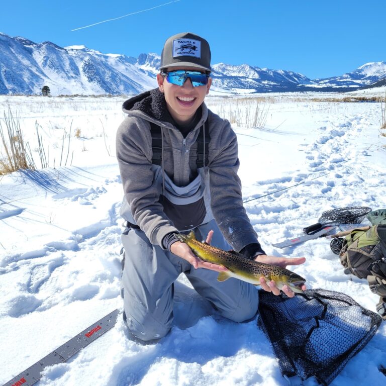FLY FISHING TEAM Dead Drift member Nick Carrillo shows off his 17-inch brown landed and released at Hot Creek after a slog through knee deep snow.