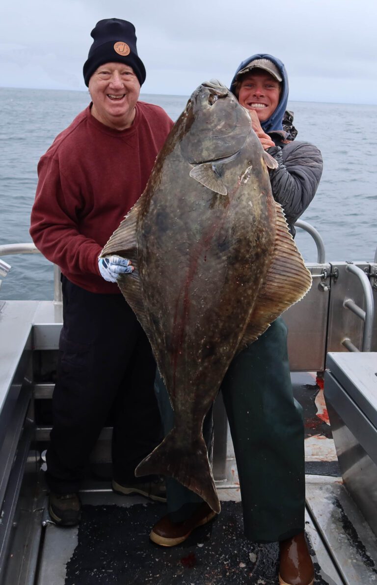 80-POUND FLATTY for Bob Semerau, left, while fishing the scampi jig aboard Predator out of J-Dock Sportfishing, Seward, Alaska.