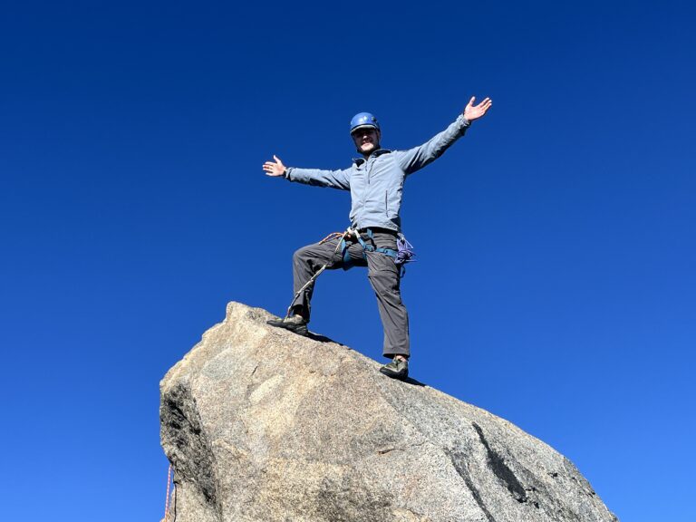 Climber Kevin Jonaitis celebrates reaching the summit of Thunderbolt Peak.