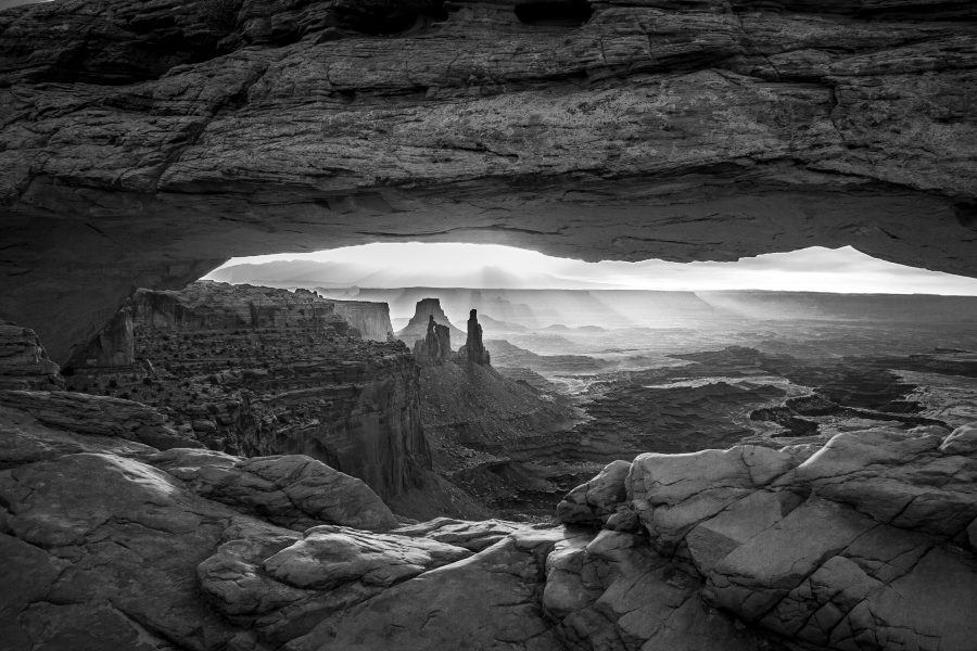 When viewing a color image of Mesa Arch at sunrise, the mind’s eye is bombarded with intense hues of yellow and orange.Converting it to monochrome highlights texture in the sandstone, shadows, and depth of the scene that might otherwise go unnoticed.