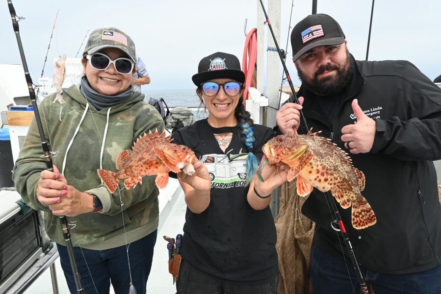 PAIR OF SCULPIN displayed by Toronado deckhand, Fatima, for Army vets Carmen Estrada, left and Paul Hernandez, right.